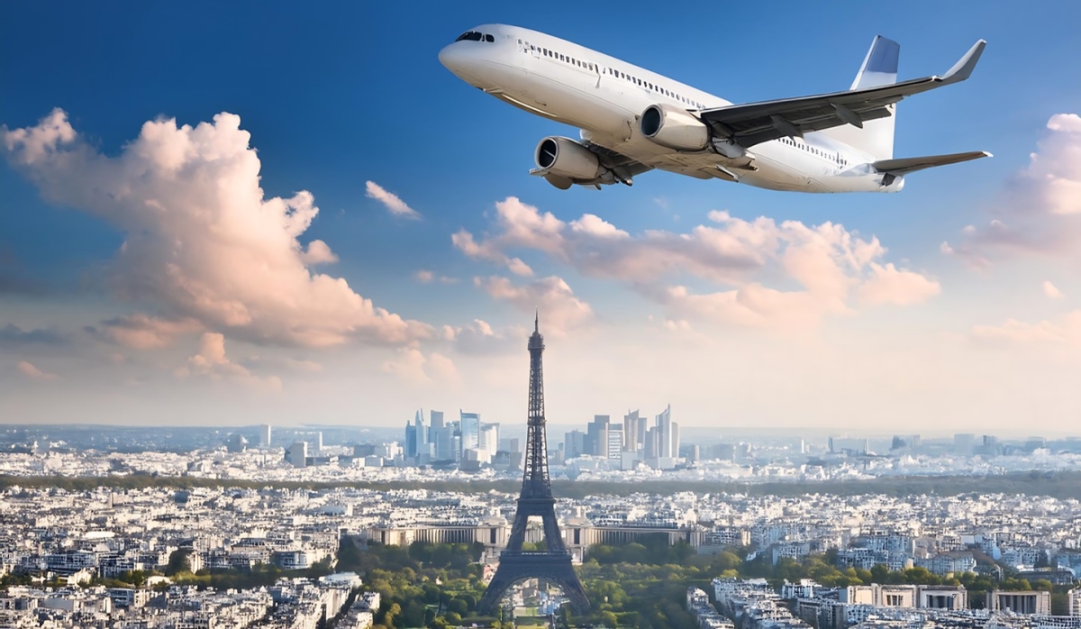 Airplane flies over the Eifel Tower